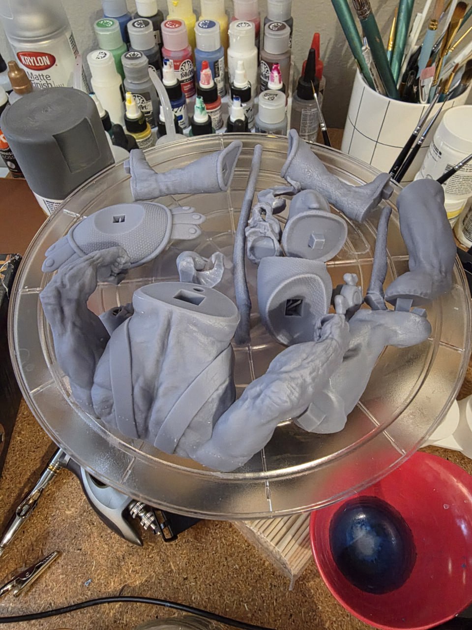 Work-in-progress hand-painted Skeletor statue parts on the painting bench before assembly.