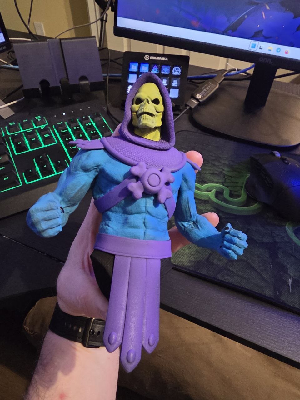 Hand-painted Skeletor statue work in progress with blue body, purple hood and armor, and yellow-green skull face.